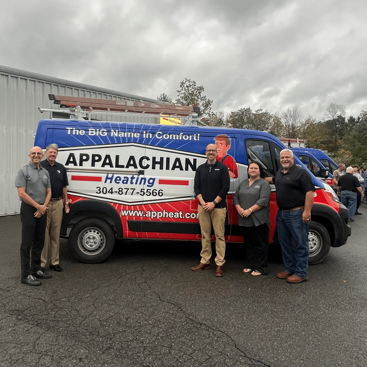 a group of people standing in front of a truck